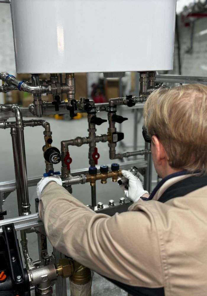 Professional plumber fixing a leaking pipe